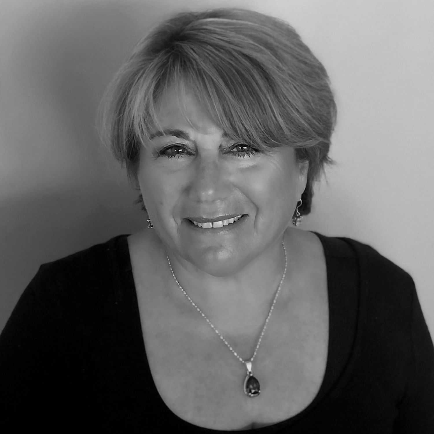 Portrait of DEBORAH LEE PARENT, a professional stylist at Cassandra Salon & Spa, showcasing their expertise and style.