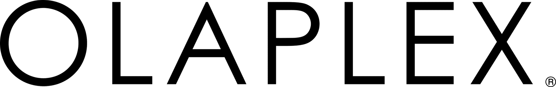 A group of people dines around a large outdoor table in a garden setting.