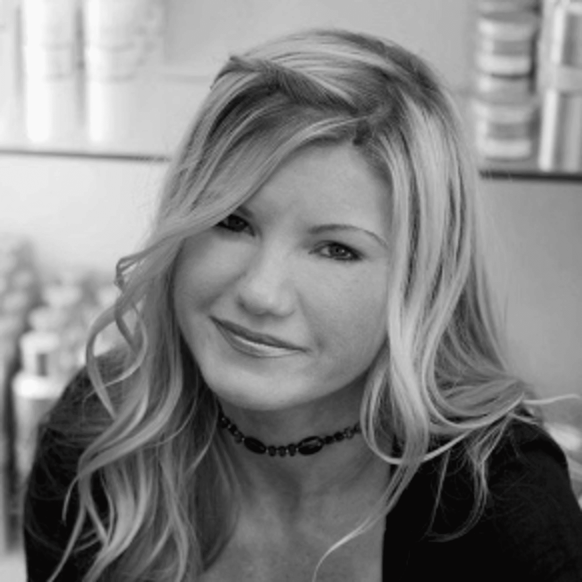 Portrait of DONNA DIONNE, a professional stylist at Cassandra Salon & Spa, showcasing their expertise and style.