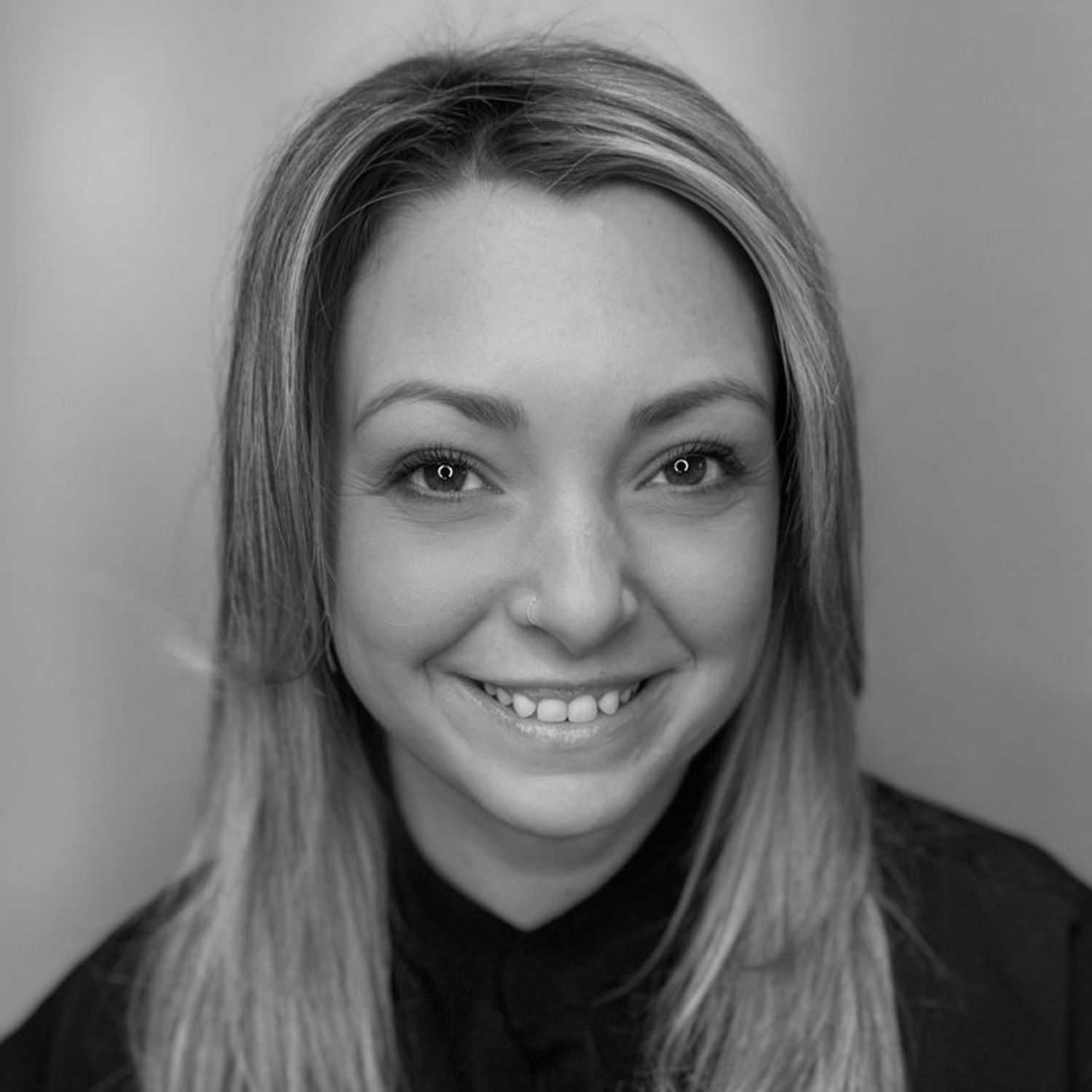 Portrait of CASSAUNDRA “CASSIE” SHEA, a professional stylist at Cassandra Salon & Spa, showcasing their expertise and style.